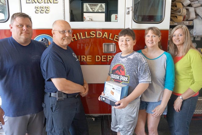 Hillsdale City Fire Department firefighter Jeff Kornack and Capt. Steve McDowell are pictured with Cole McCavit, Karla McCavit and Pamela Cross, Hillsdale ISD teacher. COURTESY PHOTO