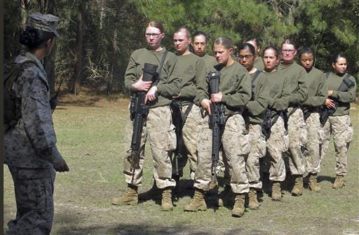 In this 2013 file photo, female recruits stand at the Marine Corps Training Depot on Parris Island, S.C. New physical standards established so women can compete for combat posts in the Marine Corps have weeded out many of the female hopefuls. But data obtained by The Associated Press shows they're also disqualifying some men.