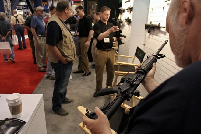 Gun enthusiasts checked out AR-15 semiautomatics at a National Rifle Association convention.