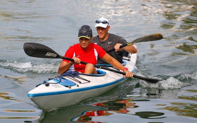 File - Cuban kayaker Lisandra Torres Castillo, left, and U.S. kayaker Joe Jacobi row together at the end of a week of training between U.S. and Cuban kayakers at the Marina Hemingway Yacht Club in Havana, Cuba, Friday, Sept. 11, 2015. (AP Photo/Desmond Boylan)