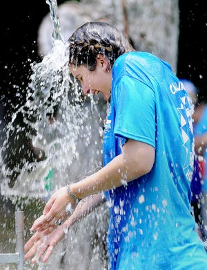 Ilyssa Sternberg, a counselor at Camp Charlie Bereavement Camp in Horsham, gets dunked Wednesday, June 22, 2016, during the camp's Carnival Day for grieving children who lost a family member. The grief-healing camp for children is marking its 10th anniversary.