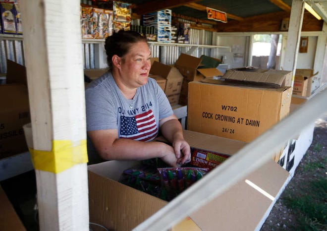 Samantha Bull stands inside her fireworks stand, Green Dragon Fireworks, at 8202 Ave. H on Wednesday in Lubbock.