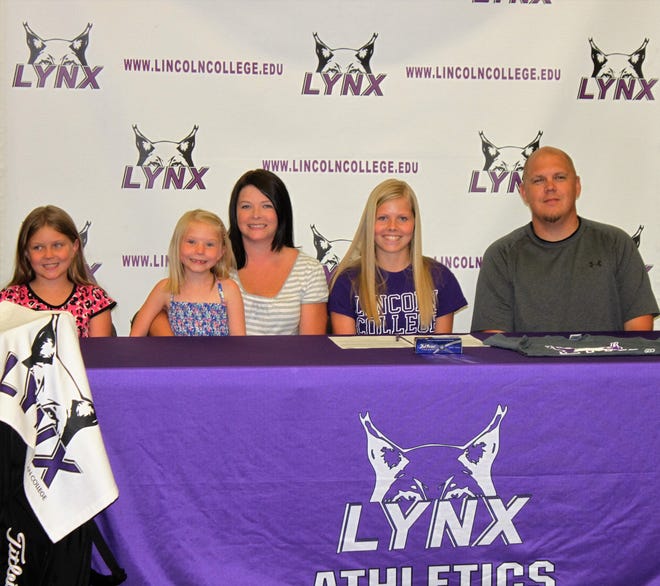Lincoln Community High School graduate Jaylee Swinford (second from right) flashes a smile after signing her National Letter of Intent to play soccer and golf for Lincoln College. Swinford signed with her family by her side Tuesday evening at the Lincoln Center in Lincoln. Photo by Sam Wood/The Courier