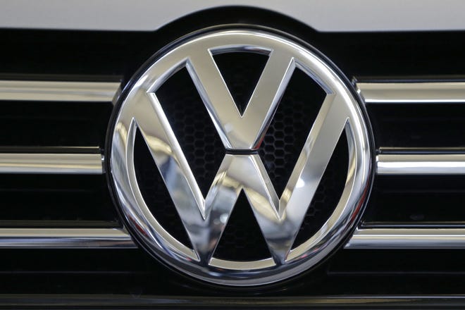 FILE - In this Feb. 14, 2013, file photo, the Volkswagen logo is seen on the grill of a Volkswagen on display in Pittsburgh. A person briefed on the matter said Thursday, June 23, 2016, Volkswagen has agreed to pay about $10.2 billion to settle claims in the U.S. from its emissions-cheating scandal. The money would go mainly to compensate 482,000 owners of cars with 2-liter diesel engines that were programmed to cheat on emissions tests. (AP Photo/Gene J. Puskar, File)