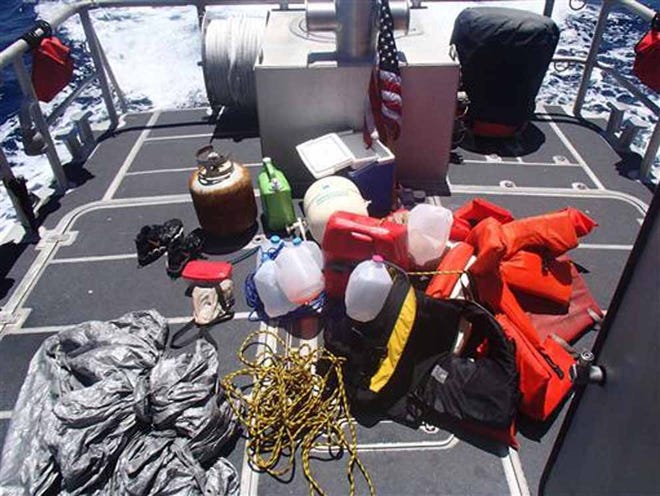 This photo made available by the U.S. Coast Guard shows personal items that were recovered within a debris field off the coast of Sanibel, Fla., Wednesday, June 22, 2016. The personal items are believed to belong to a father and his three teenage children who were reported missing while they were aboard a sailboat in the Gulf of Mexico.