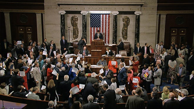 In this image from video provided by House Television, House Speaker Paul Ryan stands at the podium as he brings the House into session Wednesday night, June 22, 2016, in Washington. Rebellious Democrats staged an extraordinary all-day sit-in on the House floor to demand votes on gun-control bills, shouting down Ryan when he attempted to restore order as their protest stretched into the night. The sit-in was well into its 10th hour, with Democrats camped out on the floor stopping legislative business in the House, when Ryan stepped to the podium to gavel the House into session and hold votes on routine business. Angry Democrats chanted “No bill, no break!” and waved pieces of paper with the names of gun victims, continuing their protest in the well of the House even as the House voted on a previously scheduled and unrelated measure to overturn an Obama veto. (House Television via AP)
