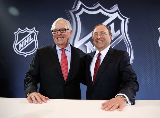 NHL Commissioner Gary Bettman, right, and Bill Foley pose for photographers during a news conference Wednesday in Las Vegas. Bettman announced an expansion franchise to Las Vegas after the league's board of governors met. Foley is the majority owner of the team.