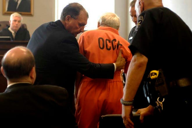 Defense attorney David Longeretta, second from left, helps his client Bruce Leonard during his plea allocution in Oneida County Court on Wednesday, June 22, 2016, in Utica, N.Y. Leonard, the father of a New York man who was beaten to death during a church counseling session pleaded guilty for his role in the attack, which also injured another son. (Micaela Parker/Observer-Dispatch via AP) ROME OUT; MANDATORY CREDIT