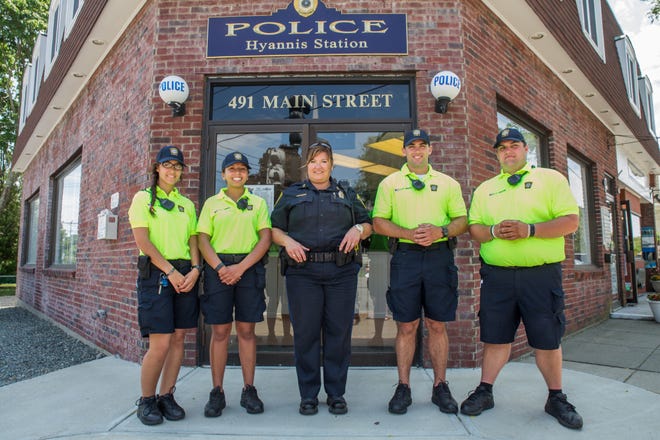 Barnstable Police Sergeant Jennifer Ellis, center, with new community service officers Rose Silva, Jazzmyn Lambert, Dennis Reddy, and John Gardiner in front of the police substation on Main Street. PHOTO BY ALAN BELANICH