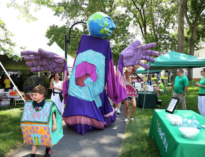 Members of Spiral Q Puppet Theater lead a parade at the  Earth Fair.