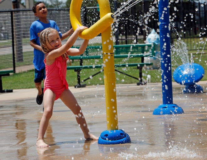 Charley Sadowsky, 4, plays in June at the splash pad at Colonial Estates Park in Norman. Emergency medical officials have issued a heat warning for the region. Officials say hot weather with high humidity is expected to continue for the next several days. [Photo by Steve Sisney, The Oklahoman]