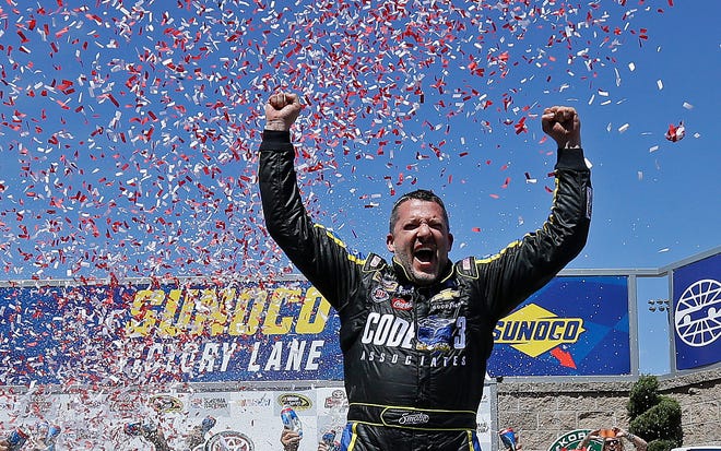 Tony Stewart celebrates after winning the NASCAR Sprint Cup Series auto race Sunday, June 26, 2016, in Sonoma, Calif. (AP Photo/Ben Margot)