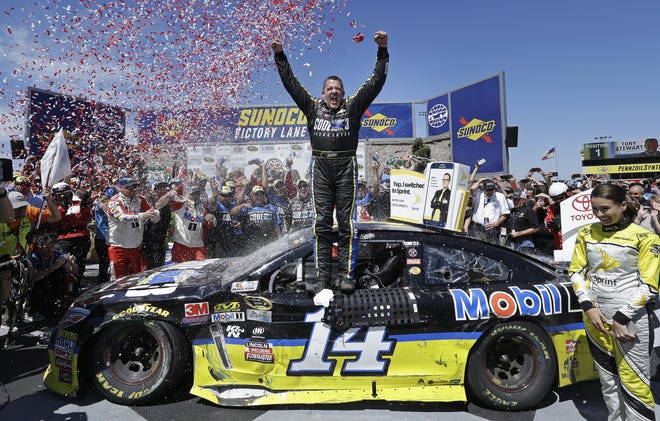 Tony Stewart, center, celebrates after winning the NASCAR Sprint Cup Series auto race Sunday in Sonoma, Calif. Associated Press/Ben Margot