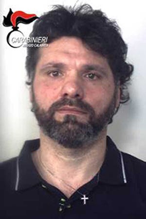 In this photo released by the Italian police Sunday, June 26, 2016, is portrayed Ernesto Fazzalari, Italy's No. 2 fugitive, a convicted 'ndrangheta crime syndicate boss feared as a ''merciless killer,'' who was captured Sunday as he slept in his bed in a hideout in the rugged Calabrian mountains after 20 years on the run, police and prosecutors said. (Italian Police/HO Photo via AP)