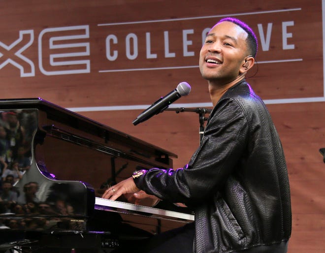 In this March 17, 2016 photo, John Legend performs during the South by Southwest Music Festival in Austin, Texas. The Springfield School District in Springfield, Ohio is nearing completion on its newly renovated John Legend Theater, and officials are trying to determine how it will be shared with the community. The $2.5 million project is expected to be completed by September. Legend donated $500,000 for the project. The Oscar- and Grammy-winning artist is a graduate of the Springfield district.