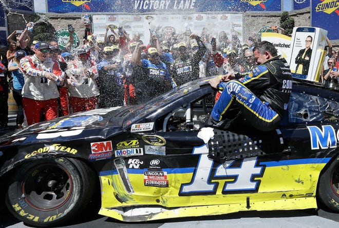 Tony Stewart is sprayed as he climbs out of his car after capturing Sunday's Sprint Cup race at Sonoma. Stewart, a three-time Cup champion, admitted he had lost confidence in his ability to regain his old form. He now will likely get to compete for a fourth title.