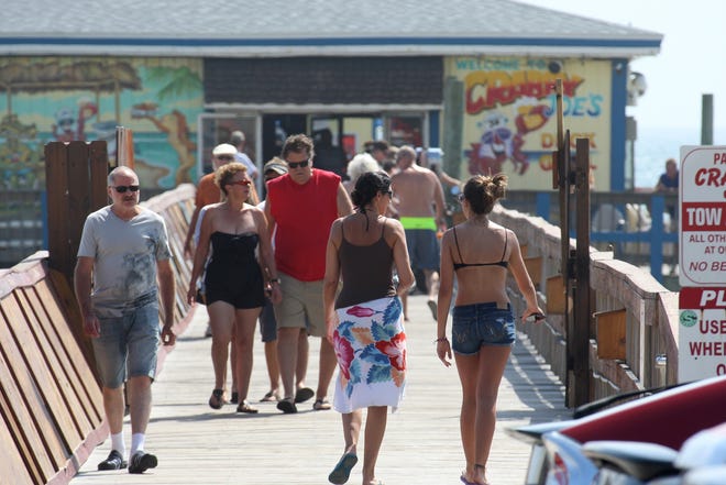 Race fans will meet beachgoers during a busy Fourth of July holiday weekend featuring the Coke Zero 400 at Daytona International Speedway Boulevard. At Sunglow Pier in Daytona Beach Shores, tourists enjoy the sun, fish and head to lunch. NEWS-JOURNAL/JIM TILLER