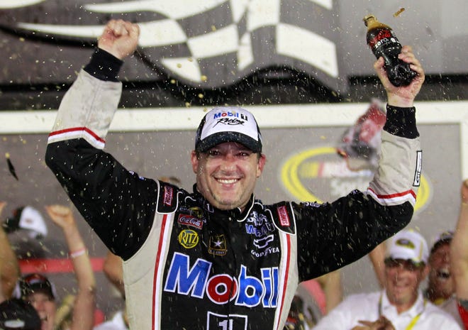 Tony Stewart celebrates after winning the 2012 Coke Zero 400. Associated Press/John Raoux
