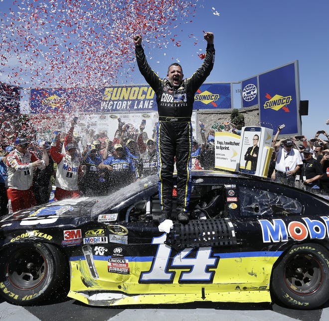 Tony Stewart celebrates Sunday's win at Sonoma, his first NASCAR victory in three years. (AP Photo/Ben Margot)