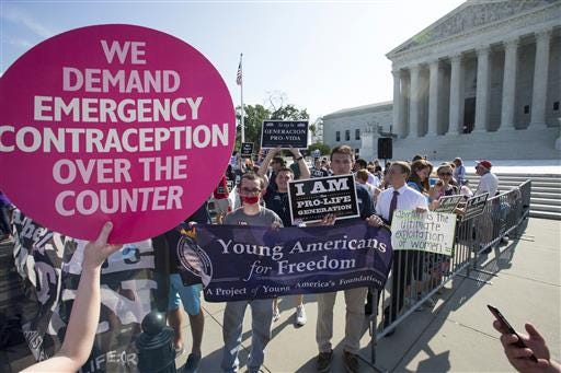 Activists demonstrate in front of the Supreme Court in Washington, Monday, as the justices close out the term with decisions on abortion, guns, and public corruption are expected.
