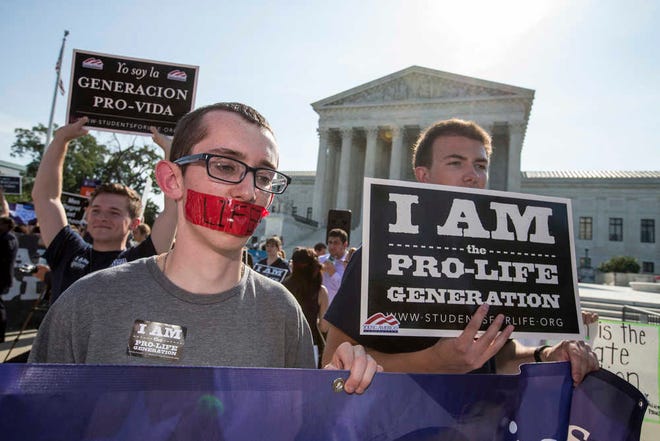 Activists demonstrate in front of the Supreme Court in Washington on Monday. The Supreme Court has struck down Texas' widely replicated regulation of abortion clinics in the court's biggest abortion case in nearly a quarter century.