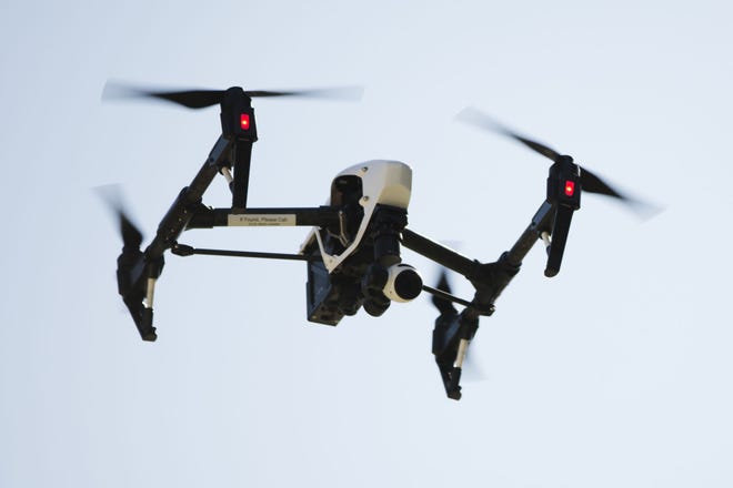 FILE - In this April 14, 2016 file photo, a drone operated captures videos and still images of an apartment building in Philadelphia. Routine commercial use of small drones was cleared for takeoff by the Obama administration Tuesday, June 21, 2016, after years of struggling to write rules that would both protect public safety and free the benefits of a new technology. (AP Photo/Matt Rourke, File)