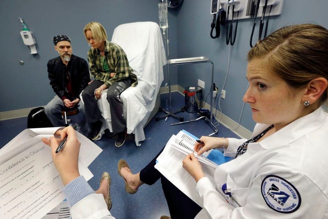 University of Massachusetts Medical School nursing student Morgan Brescia, right, and others attend a simulation of treatment for a patient coping with addiction during class at the medical school in Worcester, Mass. Many U.S. medical schools are expanding their training to help students fight opioid abuse. New training programs at many schools teach students to prescribe opioid painkillers only as a last resort, and to evaluate all patients for signs of drug abuse.