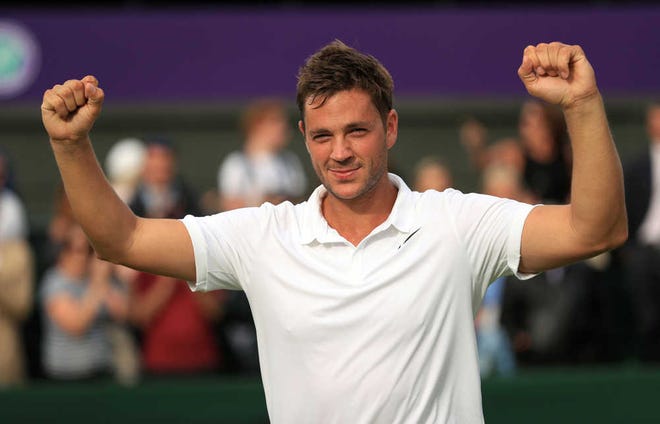 Britain's Marcus Willis, ranked 772nd in the world, celebrates his victory over 54th-ranked Ricardas Berankis, 6-3 6-3 6-4, on Monday, the opening day of play at Wimbledon, in London.