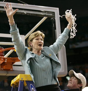 In 2008, Tennessee coach Pat Summitt holds up the net as her son, Tyler, looks on after Tennessee beat Stanford 64-48 to win its eighth national women's basketball championship. Summitt, the winningest coach in Division I college basketball history who uplifted the women's game from obscurity to national prominence during her career at Tennessee, died Tuesday morning. She was 64. (AP Photo/Gerry Broome, File)