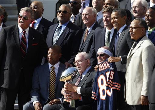 FILE - In this Oct. 7, 2011, file photo, 
President Barack Obama stands with the 1985 Super Bowl XX Champions Chicago Bears football team during a ceremony on the South Lawn of the White House in Washington. Buddy Ryan, who coached two defenses that won Super Bowl titles and whose twin sons Rex and Rob have been successful NFL coaches, died Tuesday.