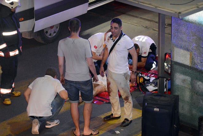 Turkish rescue services help a wounded person outside Ataturk Airport in Istanbul, Tuesday, June 28, 2016.