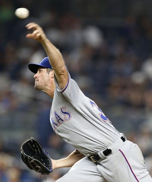 The Rangers' Cole Hamels delivers a pitch during the seventh inning against the New York Yankees in New York, Tuesday, June 28, 2016. The Rangers won 7-1.