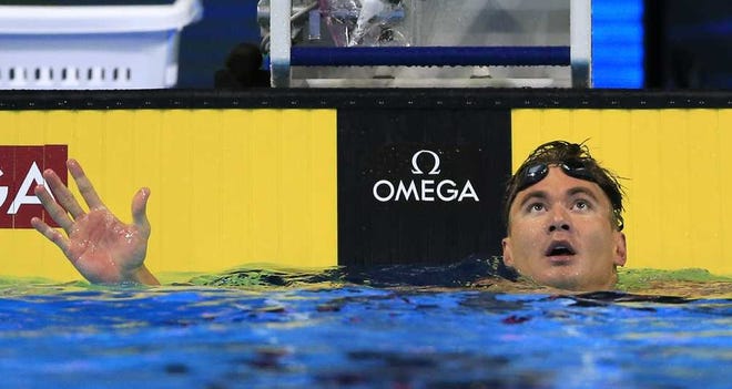 Nathan Adrian checks his time after swimming in the semifinals of the men's 100-meter freestyle on Wednesday in Omaha, Neb. He won in a time of 47.91.
