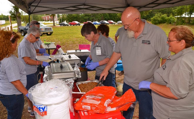 Ron and Gail Eanes, at right, are planning to build a soup kitchen, Breaking Bread for Jesus, in Wellford. While the nonprofit raises money to build the facility, volunteers are serving meals once on a month on land donated for the building.