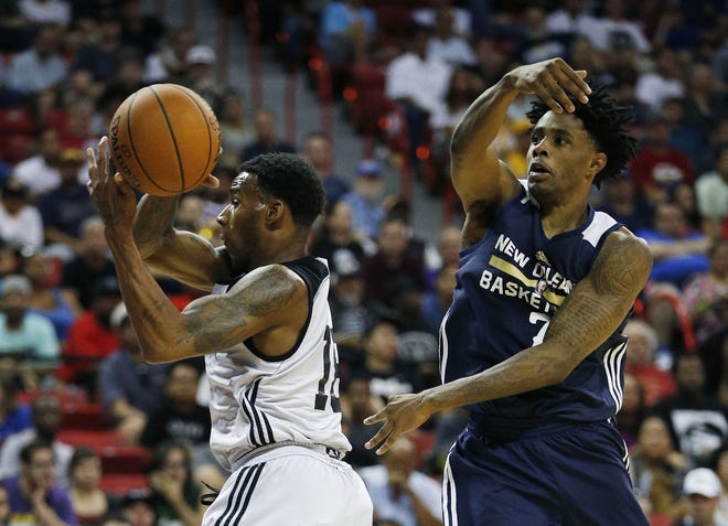 Darius Adams (left) drives the lane in a 2015 NBA summer league game. Adams will join the Dallas Mavericks this summer in hopes of landing an NBA contract. Photo by the Associated Press.