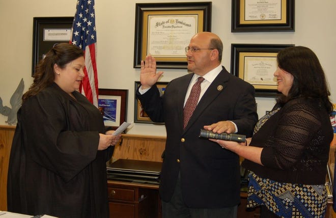 18th Judicial District Judge Elizabeth Engolio swears in Sheriff Brett Stassi as his wife, Caroline, holds the Bible.