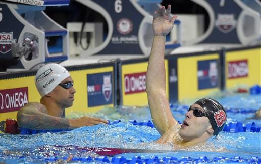 Ryan Held, right, reacts in front of Anthony Ervin, left, after their heat in the men's 100-meter freestyle semifinals at the U.S. Olympic swimming trials, Wednesday, June 29, 2016, in Omaha, Neb. (AP Photo/Mark J. Terrill)