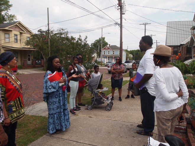 Islah Speller (left), founder of the Burnett-Eaton Museum Foundation, stands with community memebers before the start of the Black American Area History Heritage Walk and Tour. ELIZABETH MONTGOMERY/STARNEWS