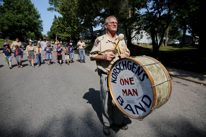 Stephen Freitag, assistant scoutmaster for Troop 65, carries the Korschgen’s One Man Band drum at the start of the 100th annual Charlie Korschgen Kiddie Parade in 2012. The parade is the United States’ oldest Fourth of July patriotic kiddie parade.