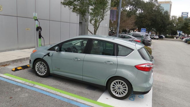 A 2014 Ford C-Max Energi charges at Jacksonville's Museum of Science and History, which has two EV charging stations that were built as part of a grant.