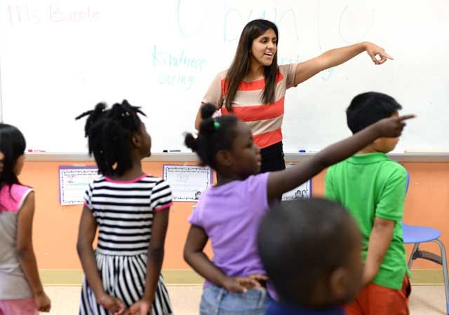 Elizabeth Mendez, part of the Teach for America program, directs first-grade students at Northeast Elementary in Kinston on Wednesday.