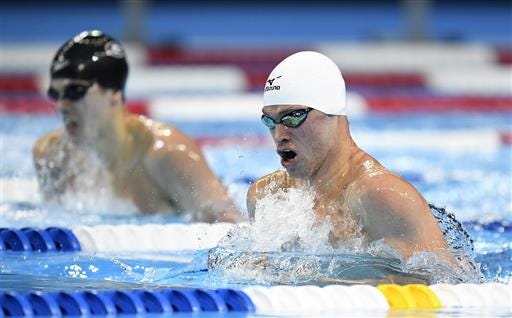 Kevin Cordes, right, swims next to Nick Fink during a men's 200-meter breaststroke semifinal at the U.S. Olympic swimming trials on Wednesday in Omaha, Nebraska.