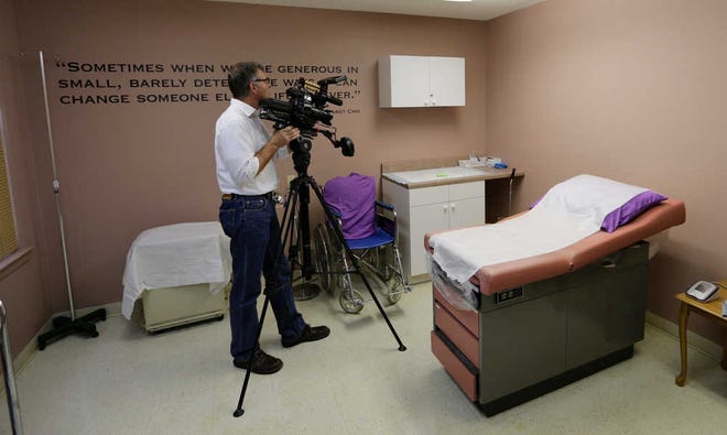 A member of the media works in a room formally used as an examination room for abortions at Choice Clinic, formerly Whole Woman's Health Clinic, on Monday in Austin.