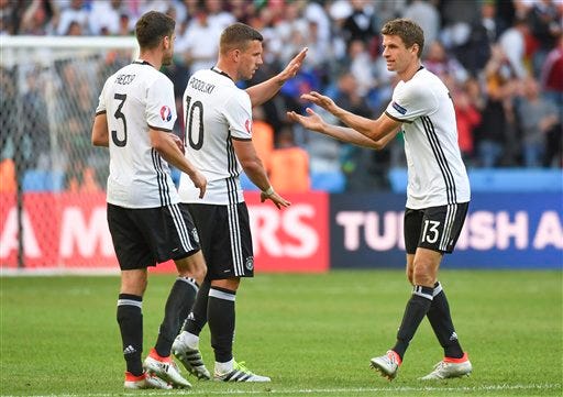 Germany's Jonas Hector, Lukas Podolski and Thomas Mueller, from left to right, celebrate at the end of the Euro 2016 round of 16 soccer match between Germany and Slovakia, at the Pierre Mauroy stadium in Villeneuve d'Ascq, near Lille, France, Sunday, June 26, 2016. (AP Photo/Geert Vanden Wijngaert)