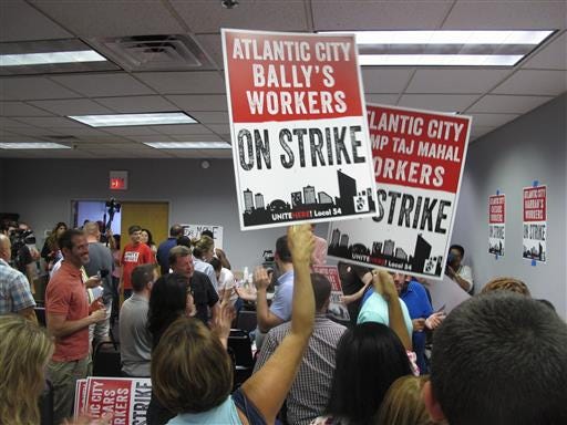 Union members cheer as they discuss preparations for a strike against as many as five of the city's eight casinos in Atlantic City, N.J. on Wednesday June 29, 2016. Local 54 of the Unite-HERE union says it will go on strike Friday if it can't reach new contracts with three casinos owned by Caesars Entertainment (Bally's, Caesars and Harrah's) and two casinos owned by billionaire investor Carl Icahn (the Tropicana and the Trump Taj Mahal). About 6,500 of the union's nearly 10,000 workers are at the five hotels. (AP Photo/Wayne Parry)