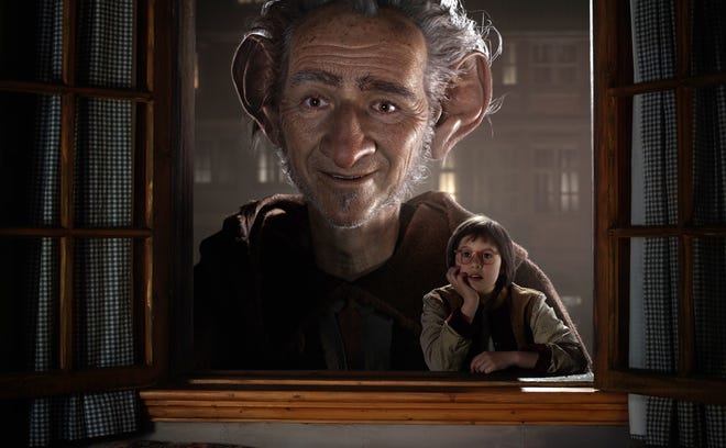 Ruby Barnhill portrays Sophie, right, in a scene with the Big Friendly Giant, voiced by Mark Rylance in "The BFG," opening Friday. Disney via AP