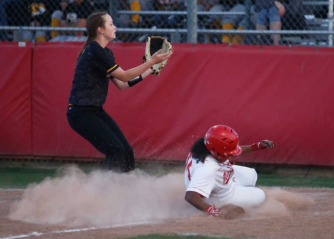 Coronado's McKenzie Cristan safely slides into home on a wild pitch past Snyder's Meagan Leatherwood during Coronado's 10-0 victory against Snyder on Tuesday, March 15, 2016, at Rosenow Field in Lubbock, Texas. (Brad Tollefson/A-J Media)