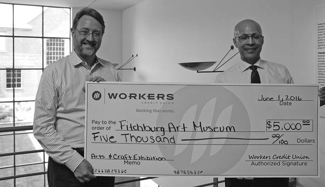 Fitchburg Art Museum Director Nick Capasso, left, thanks Workers Credit Union’s Darryl Richardson, assistant vice president, branch manager, for sponsoring through its Charitable GiveBack Program the museum’s 81st Regional Exhibition of Art & Craft, which will be on display through Sept. 4.