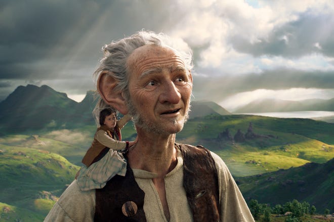 This image released by Disney shows Ruby Barnhill and the Big Friendly Giant from Giant Country, voiced by Mark Rylance, in a scene from"The BFG." (Disney via AP)