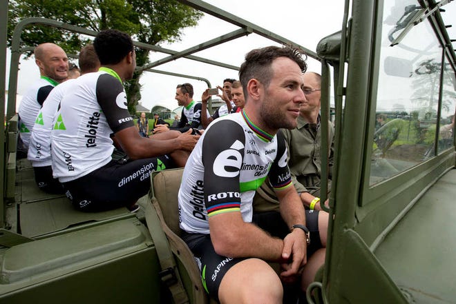 Britain's sprinter Mark Cavendish, front, and his Dimension Data teammates ride in a World War II jeep during the official team presentation two days before the start of the Tour de France cycling race in Sainte-Mere-Eglise, France, Thursday, June 30, 2016. (AP Photo/Peter Dejong)